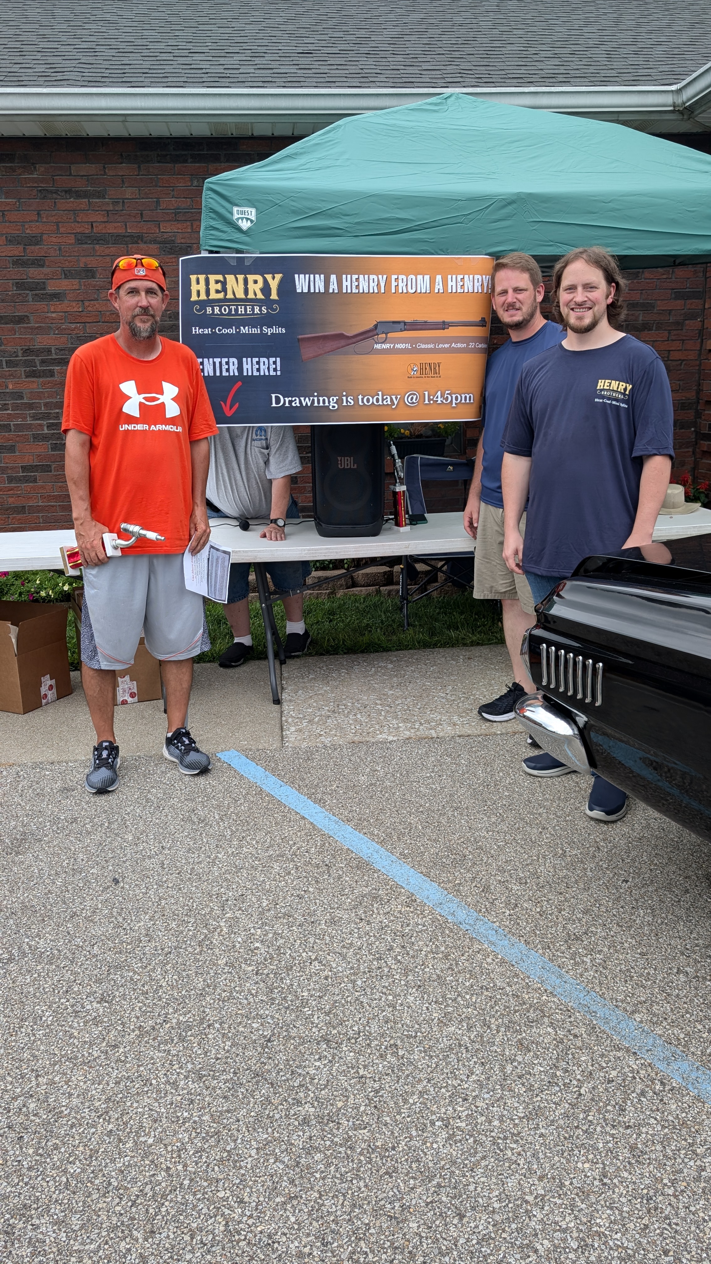 Henry Brothers team member with raffle winner at community event Jeffersonville Indiana