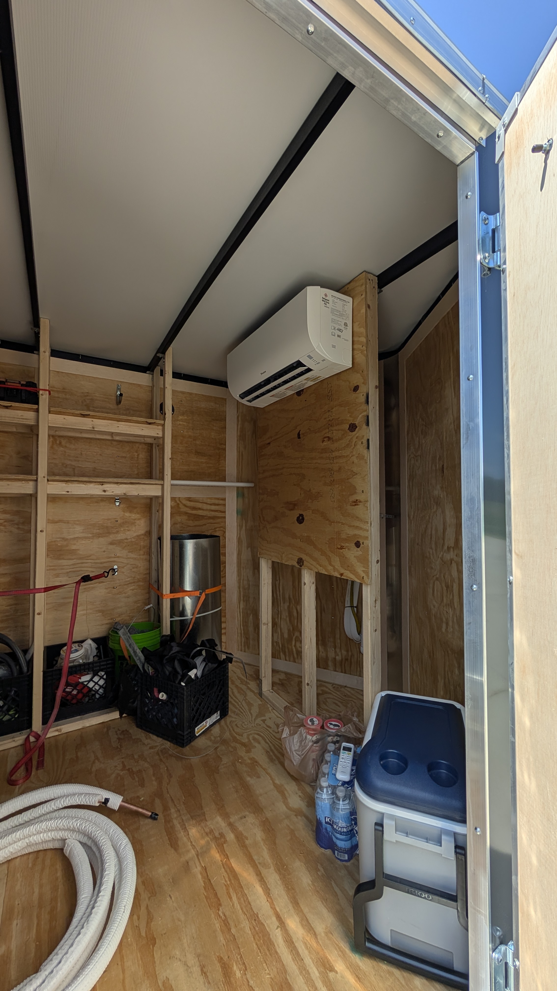 Mini-split wall-mount indoor unit installed inside Henry Brothers work trailer
