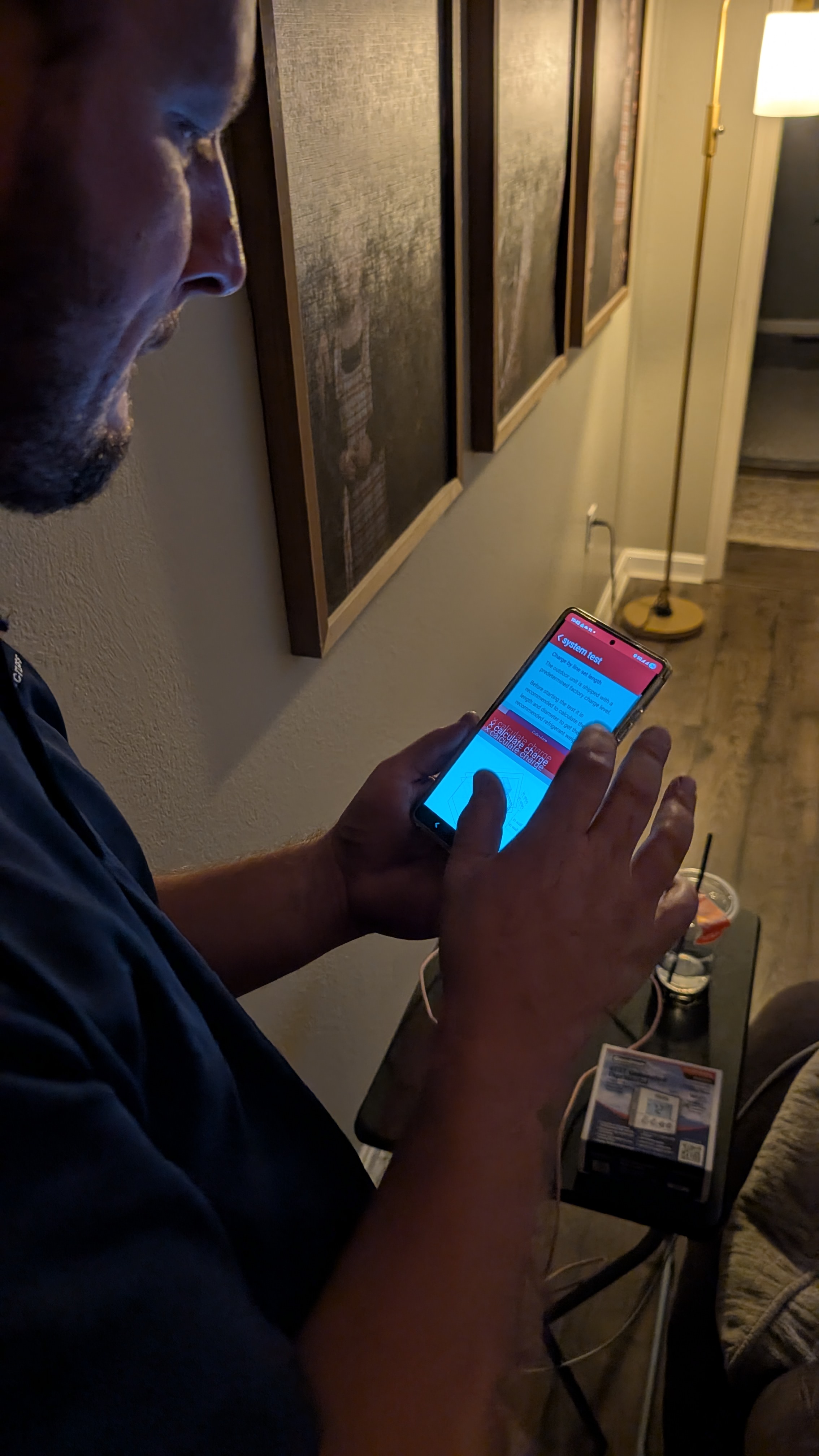 Henry Brothers HVAC technician reviewing system test results on phone Memphis Indiana