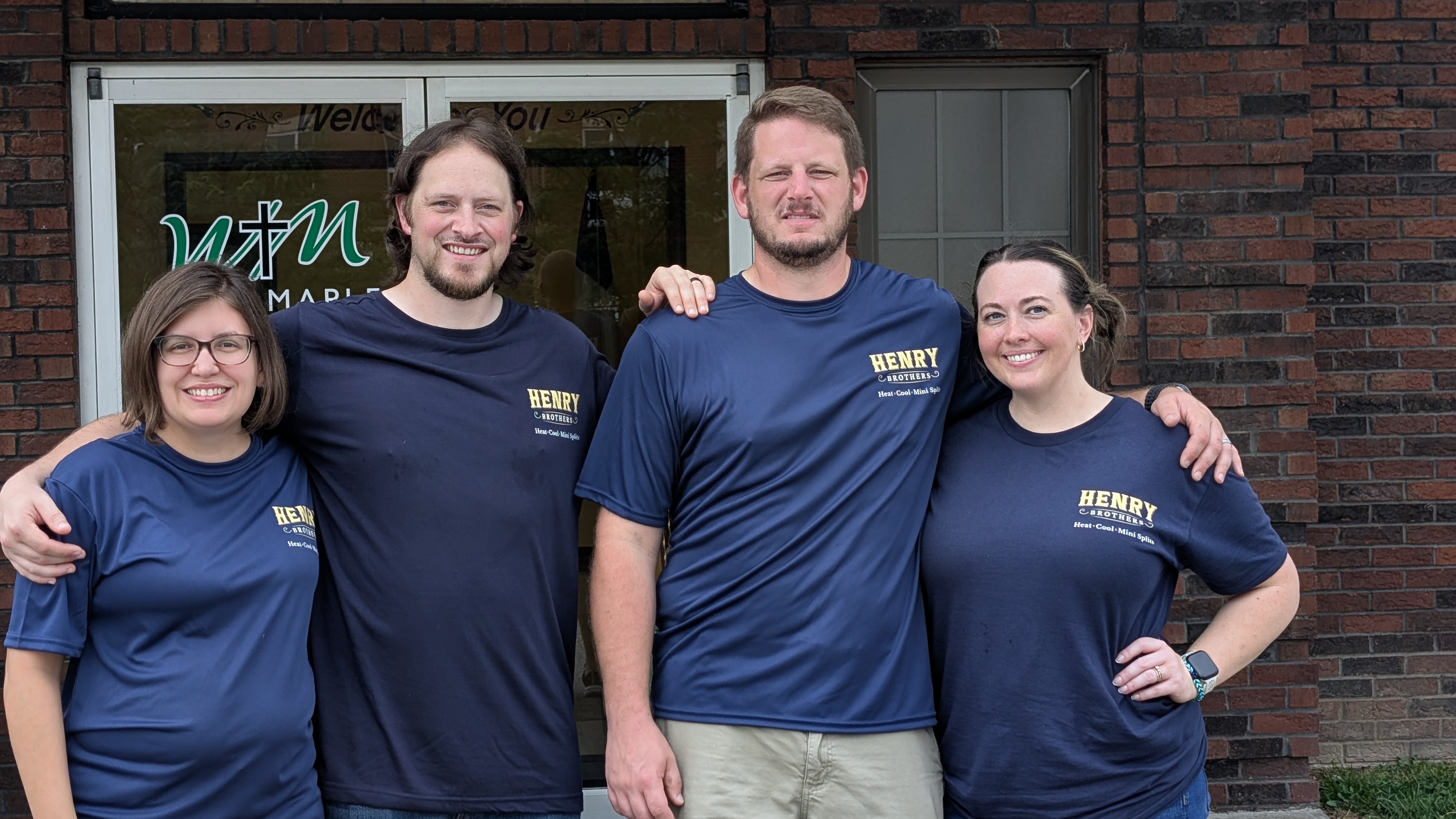 Henry Brothers mini-split HVAC team of four in branded shirts Jeffersonville Indiana