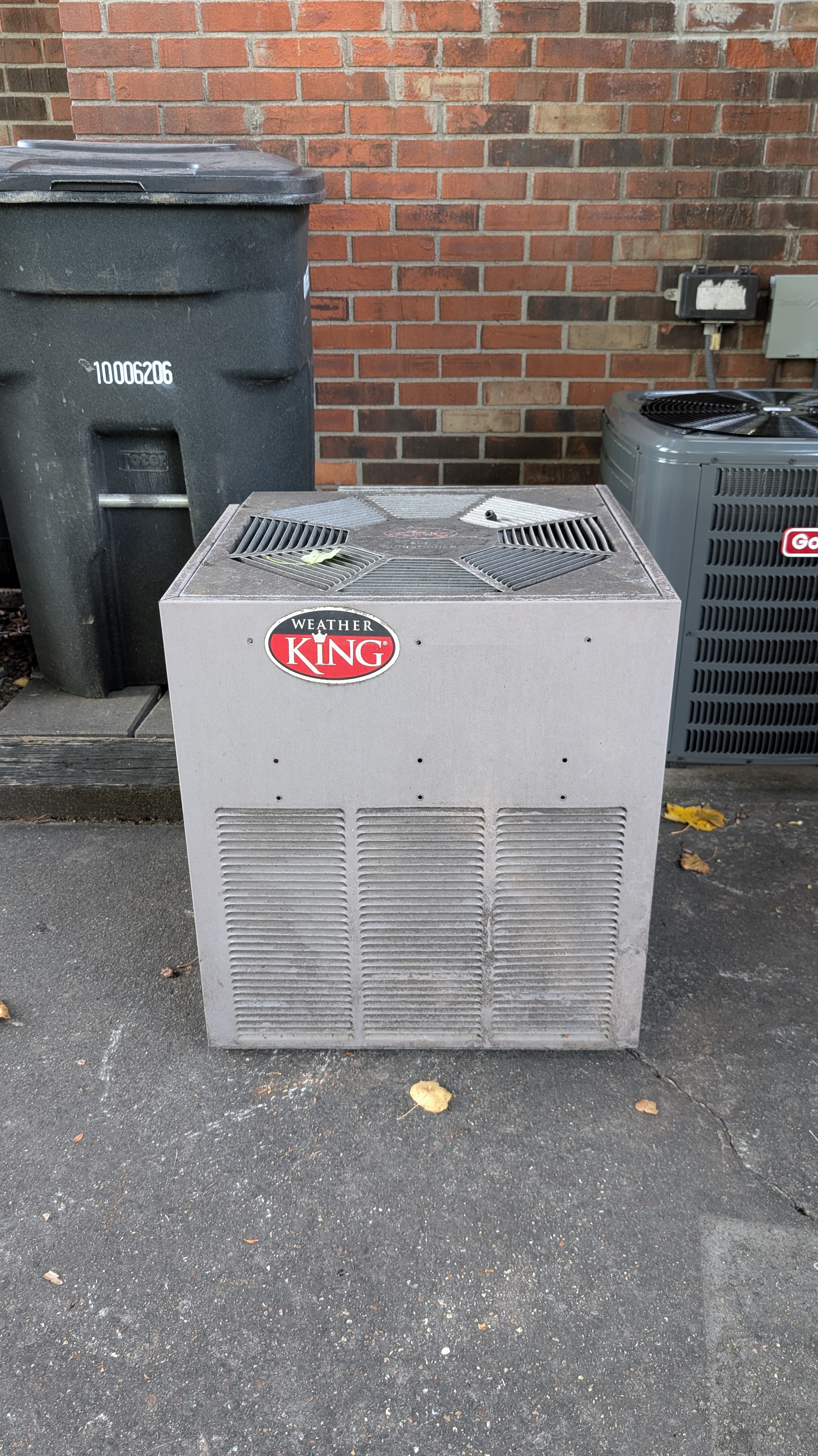 Old Weather King central AC condenser before removal at Jeffersonville Indiana home repair job