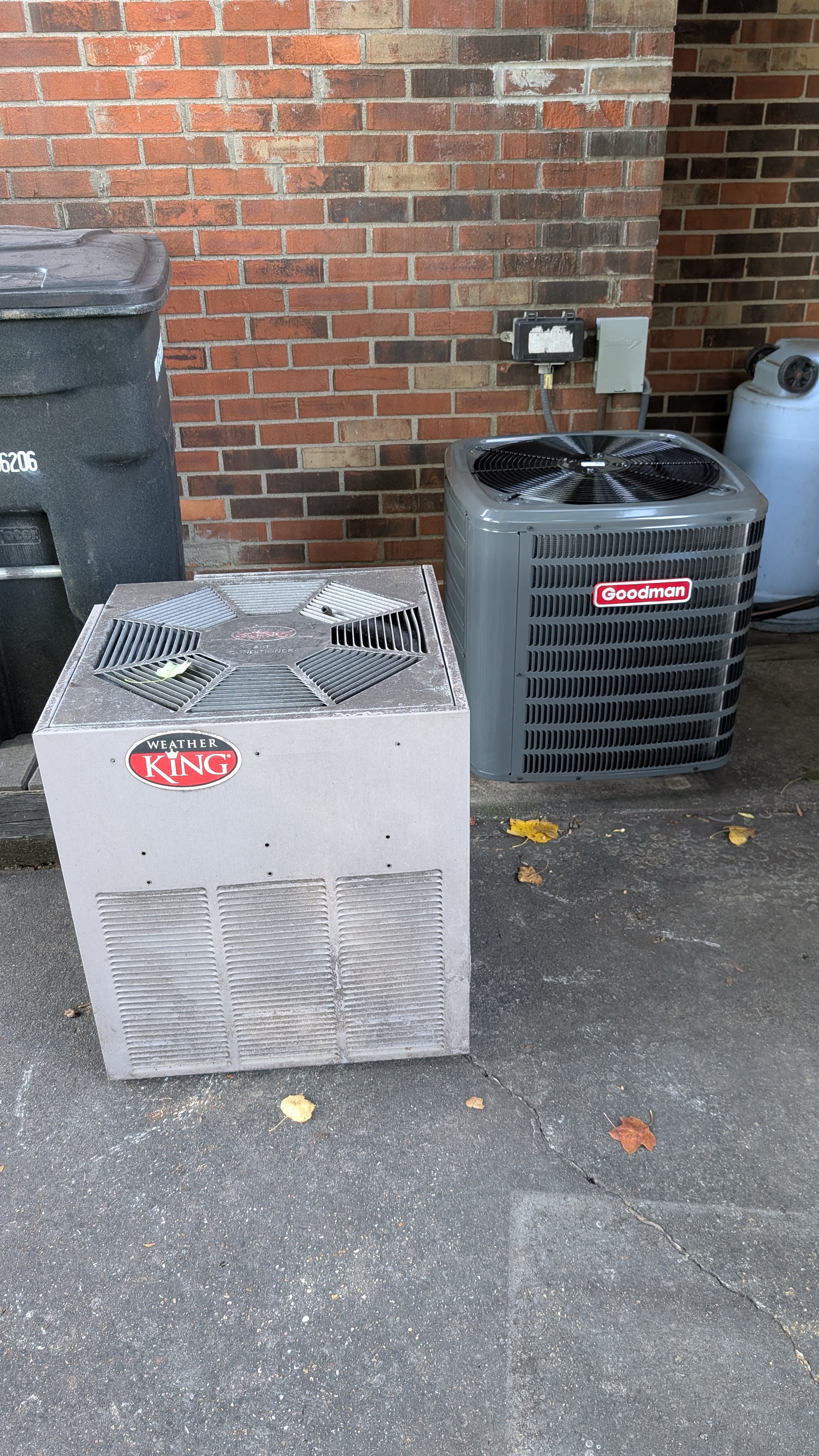Old Weather King and Goodman central AC condensers side by side during Jeffersonville HVAC repair job
