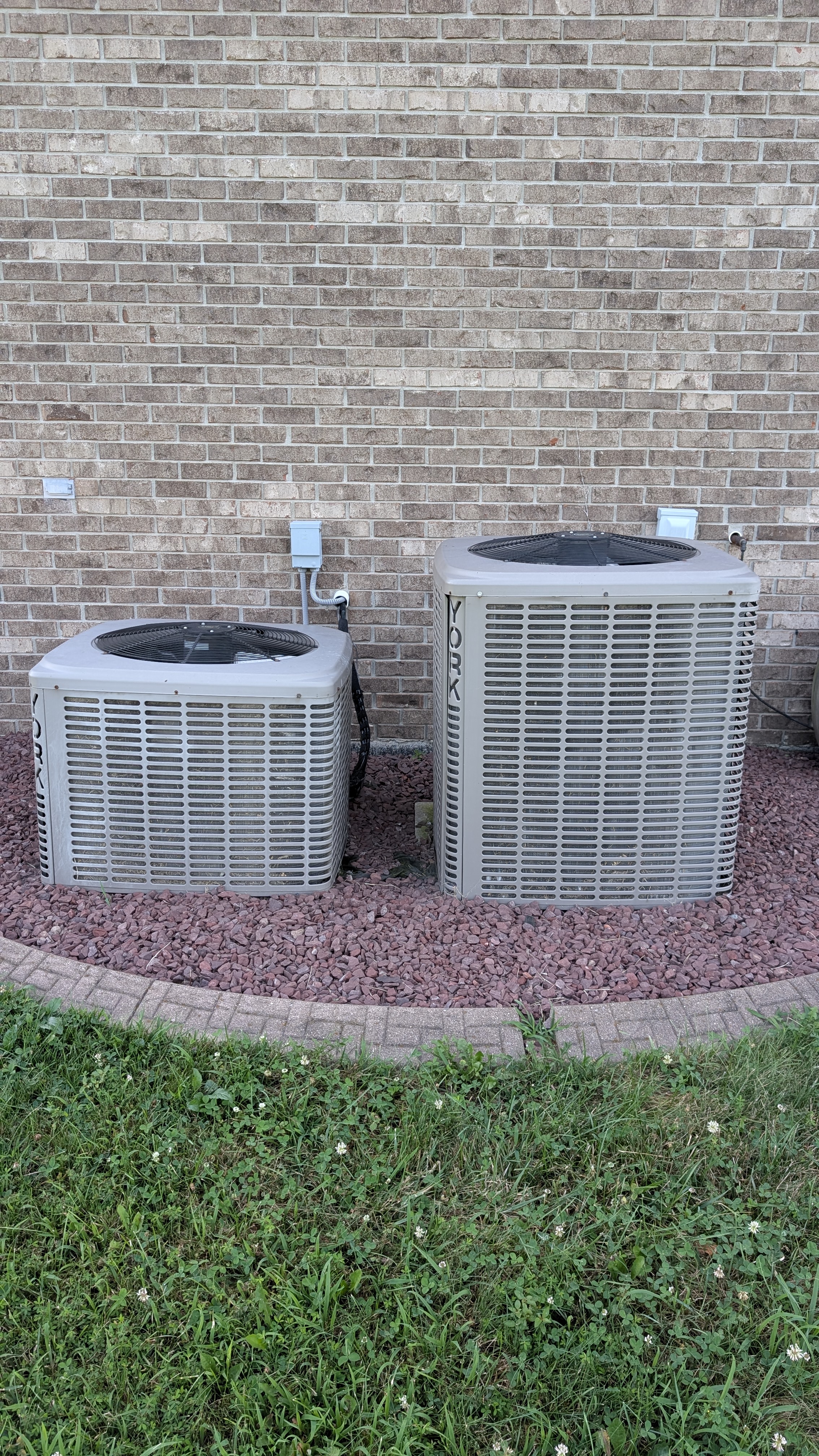 Two existing York central AC condensers before mini-split installation in Clark County Indiana