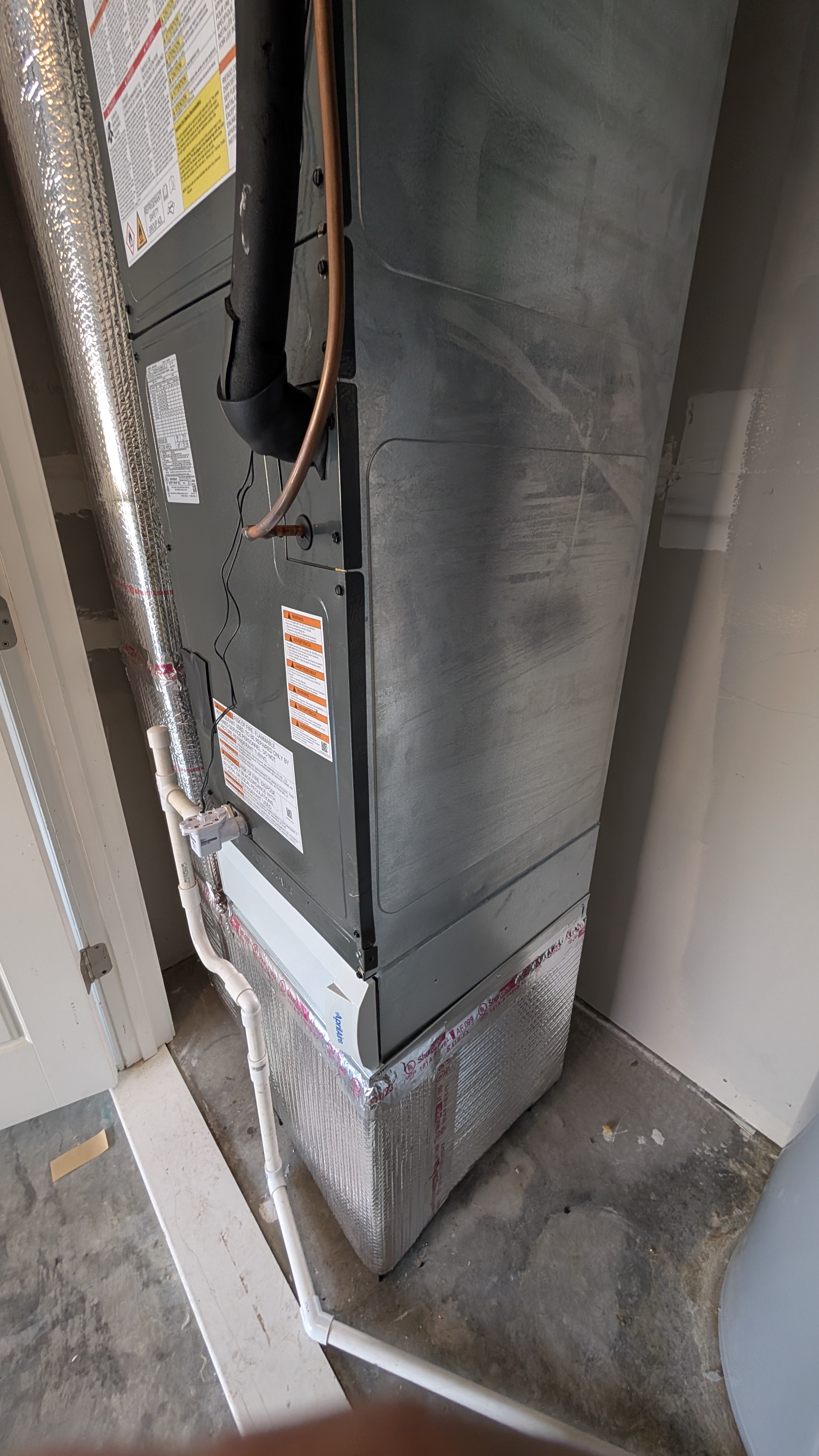 Insulated coil plenum and PVC condensate drain lines at a newly installed air handler in Clark County Indiana