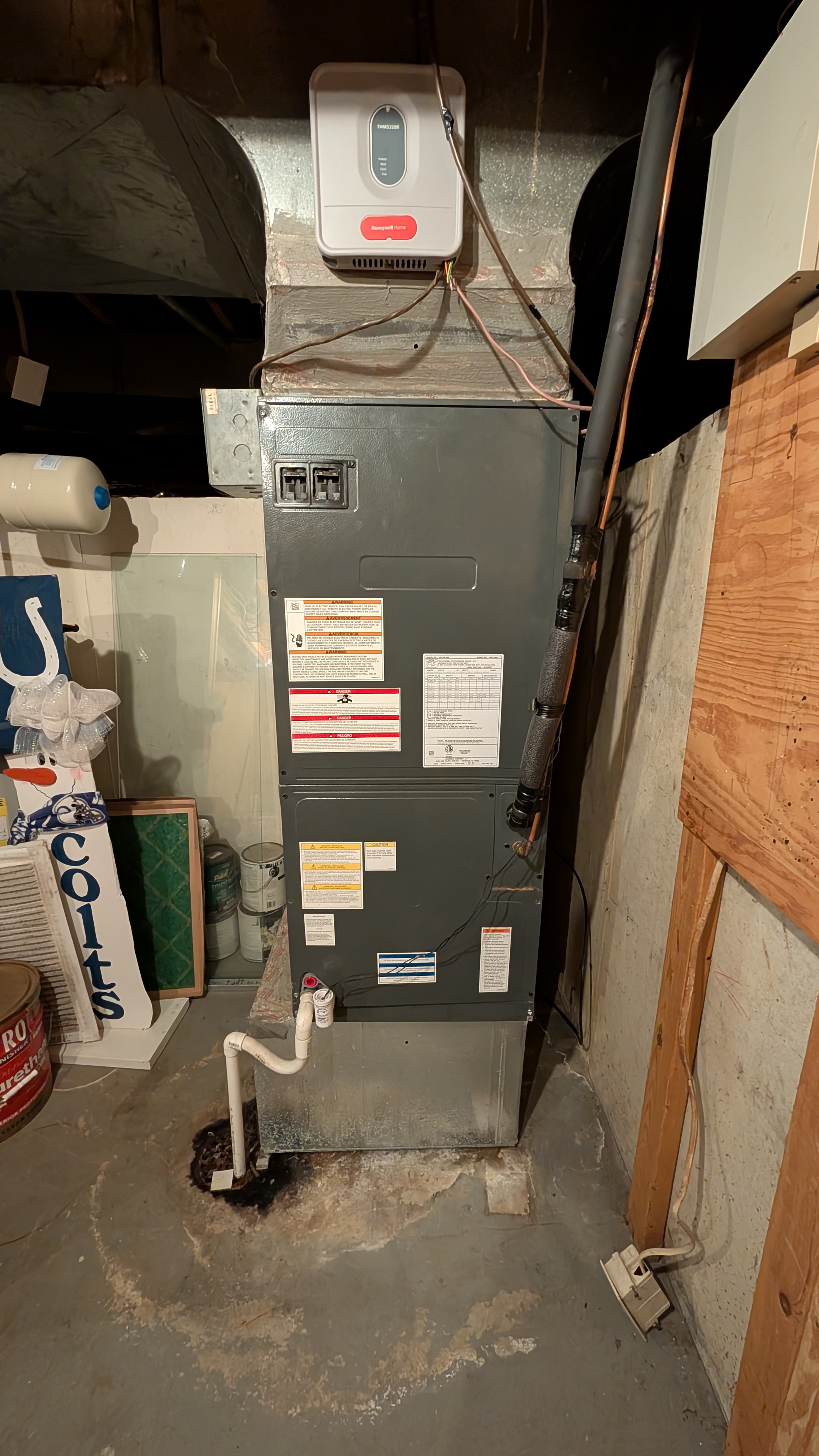 Existing air handler unit in basement with Honeywell controller before replacement