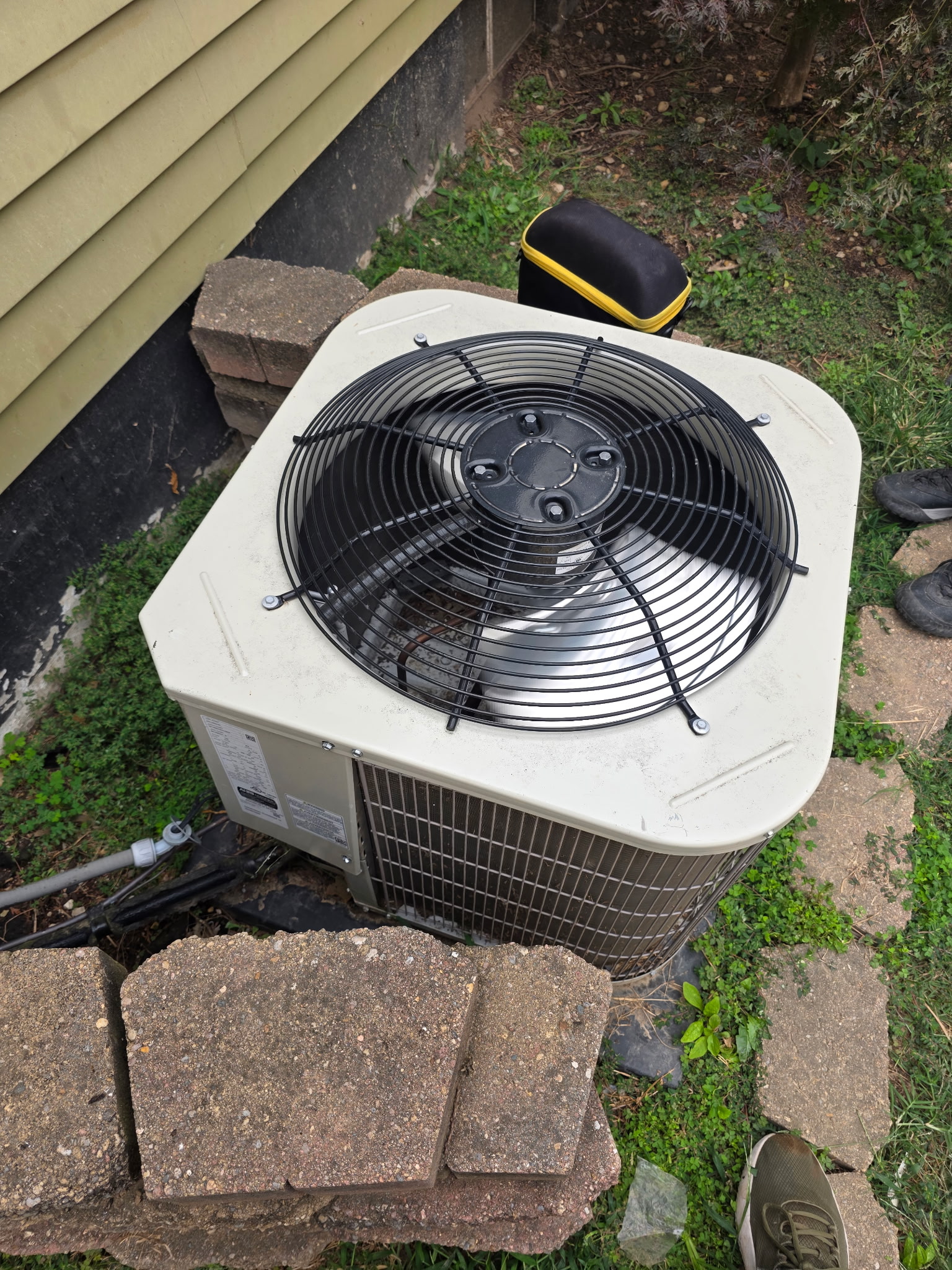 Top-down view of older central air condenser fan during HVAC second opinion inspection visit