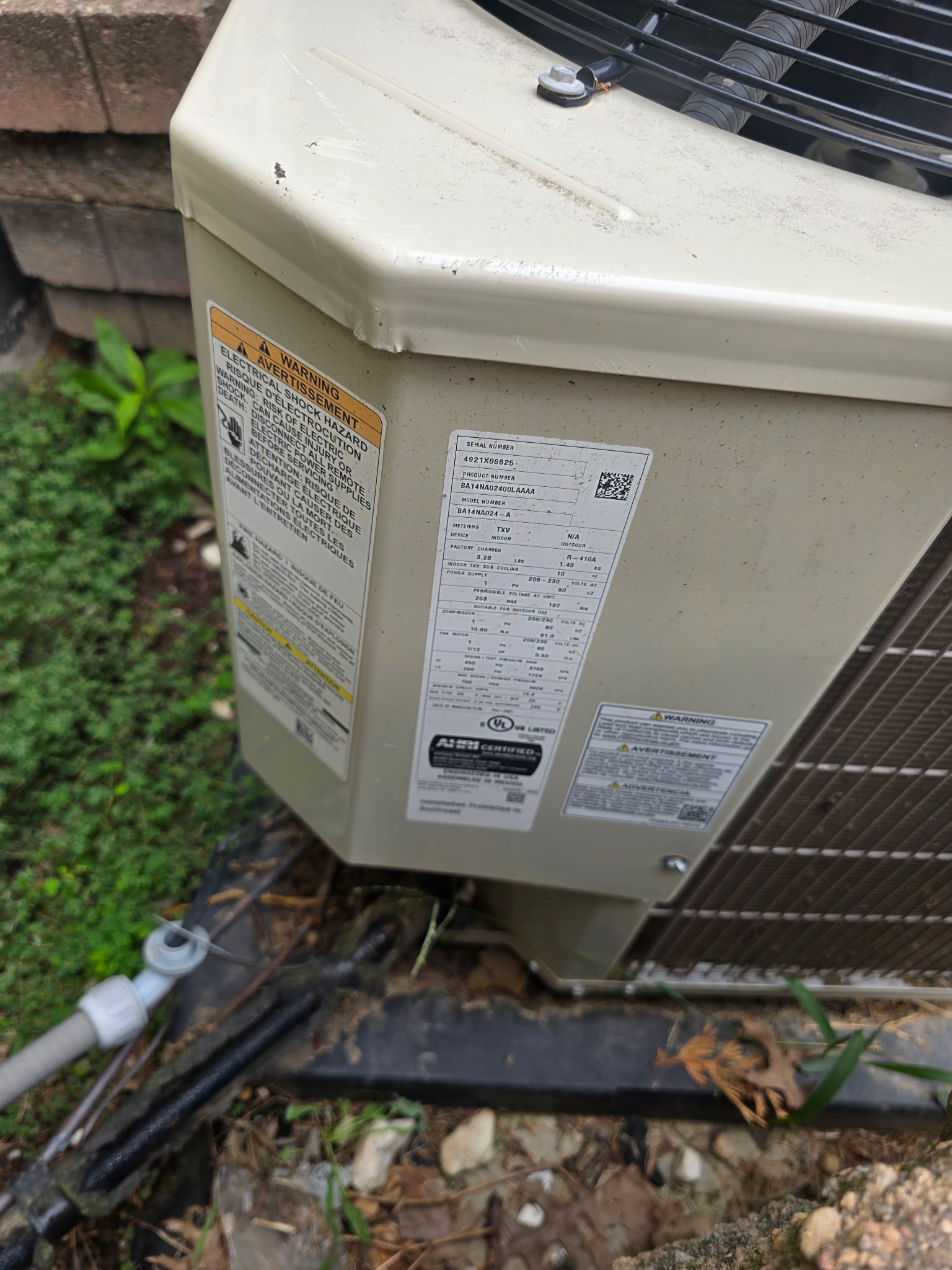 Central AC condenser data plate showing model and serial number recorded during an HVAC second opinion inspection