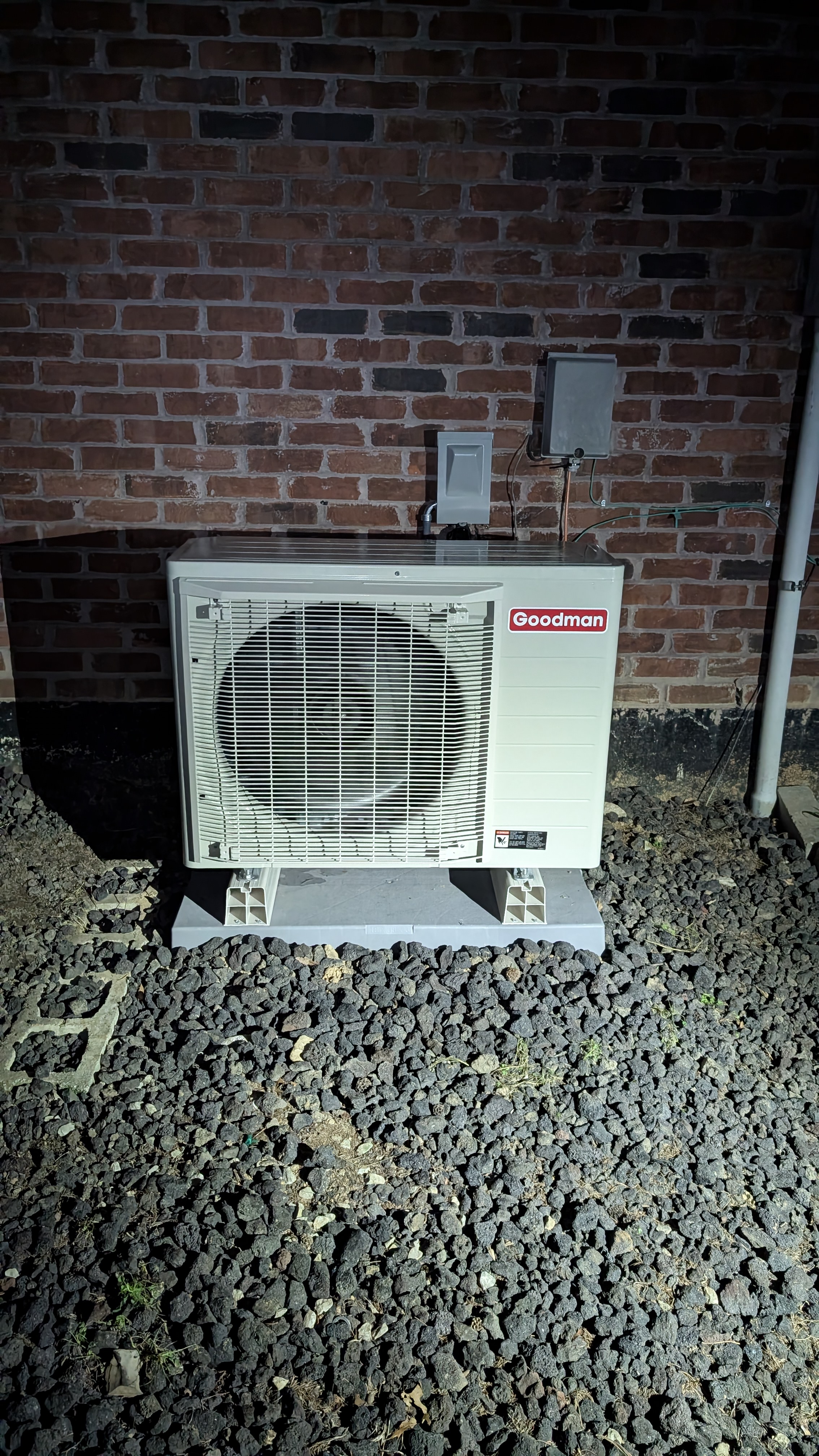 Completed Goodman mini-split outdoor unit illuminated at night Memphis Indiana after install