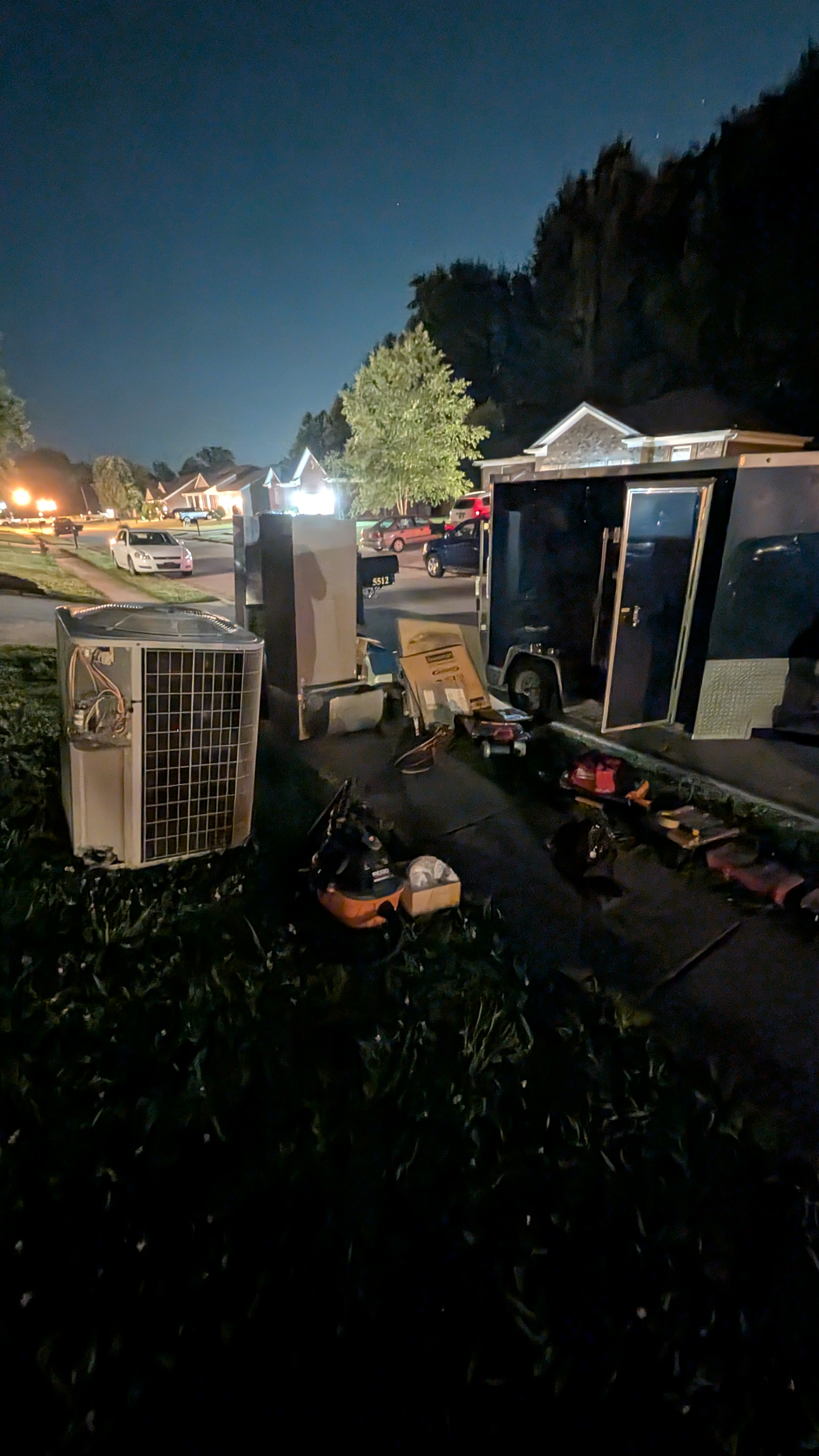 Henry Brothers HVAC job site at night with mini-split unit and work trailer Memphis Indiana