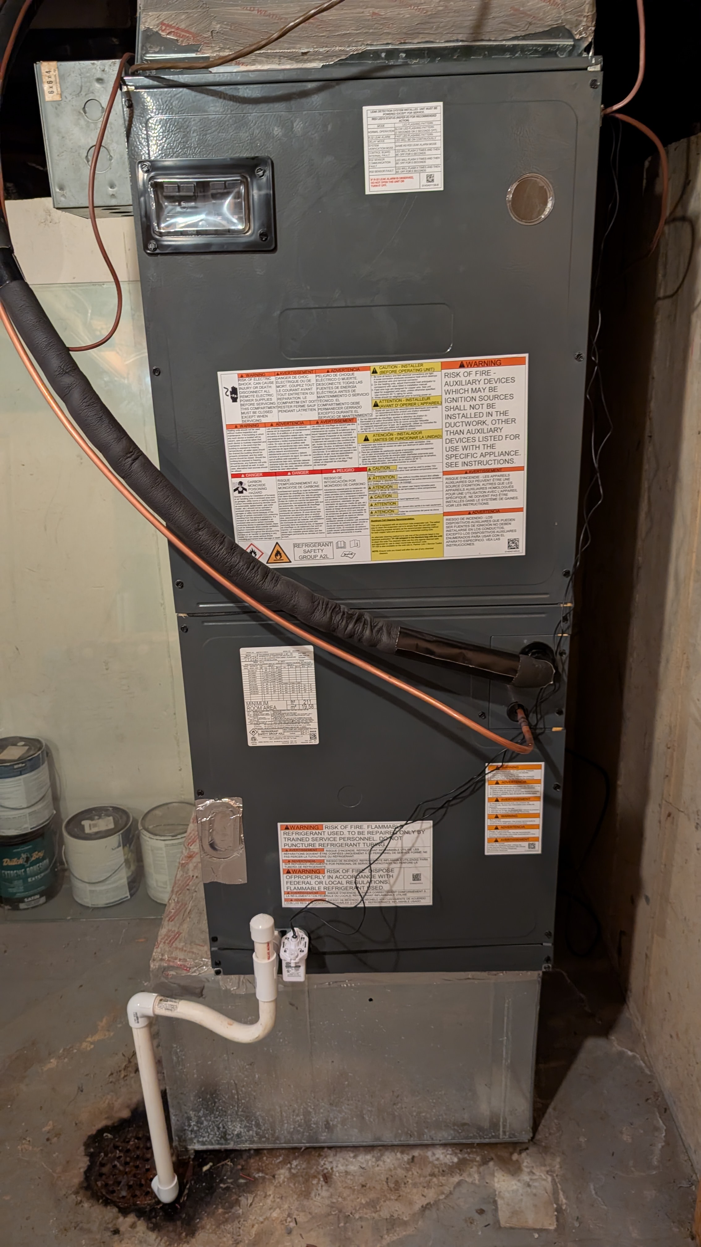 New Daikin air handler installed in basement with refrigerant lines