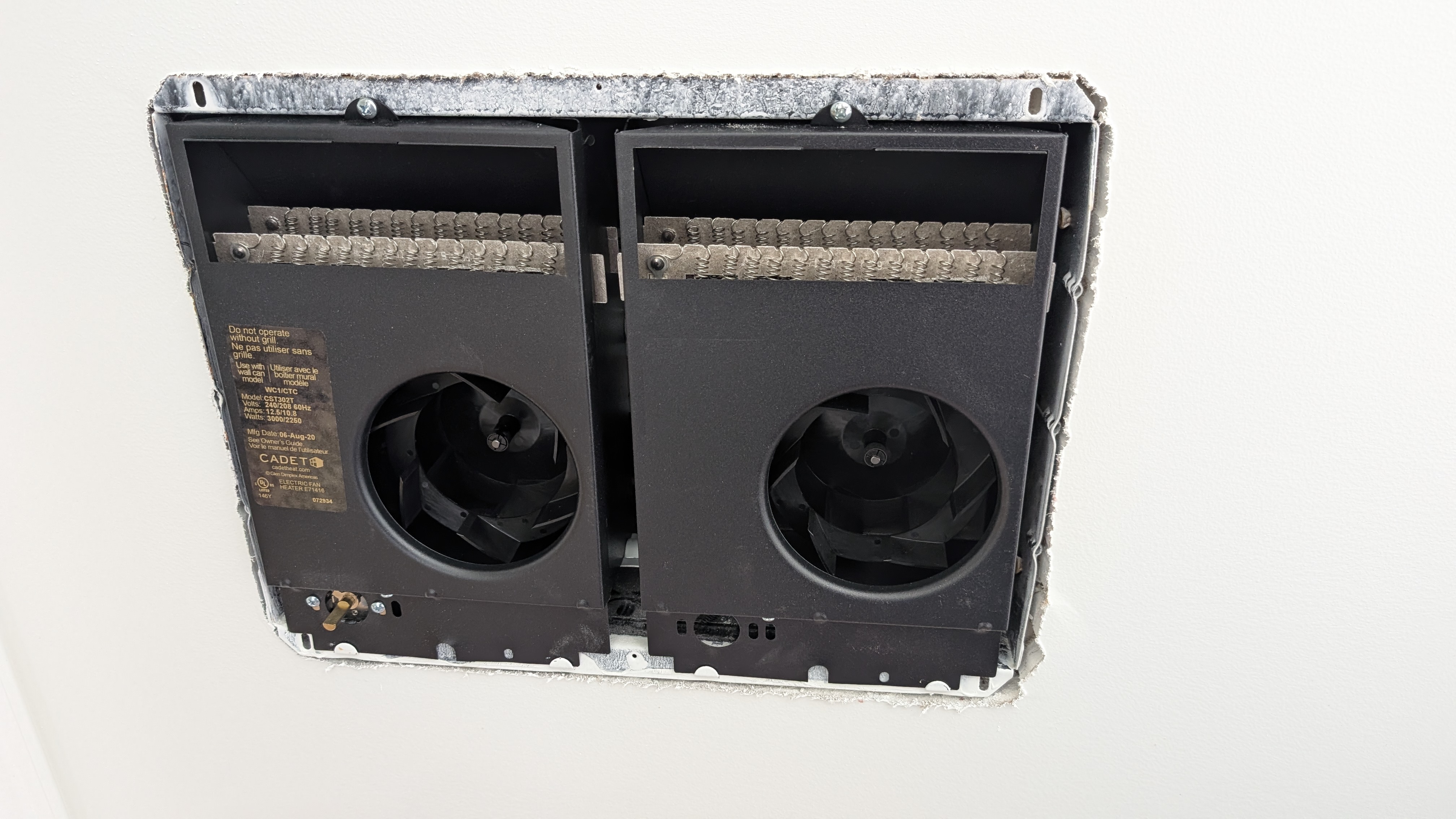 Cadet electric ceiling heater removed from ceiling showing old heating equipment being replaced by mini-split
