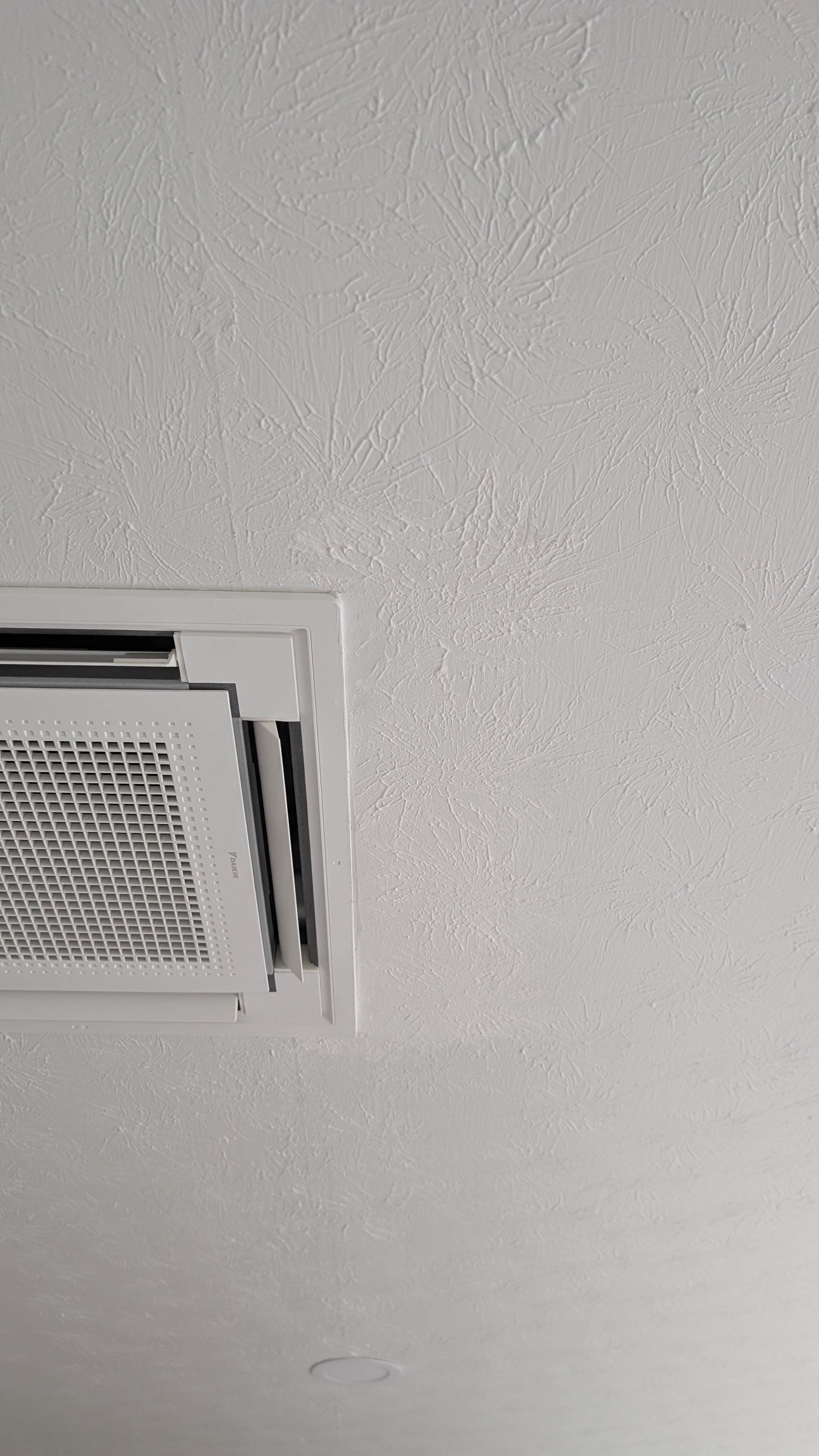 Daikin ceiling cassette mini-split indoor unit fully installed and trimmed in finished room
