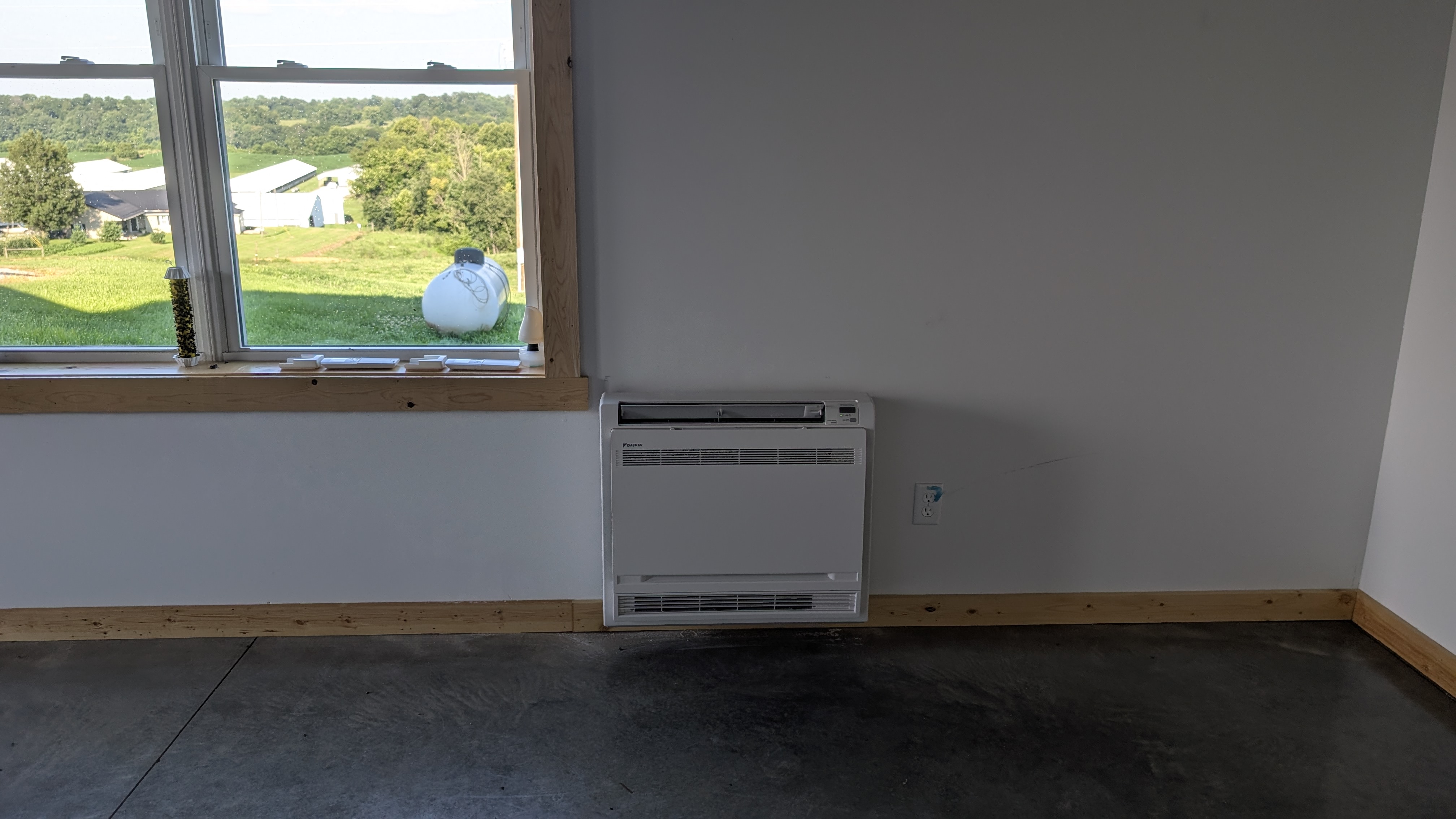Daikin floor-console mini-split with window view of Washington County Indiana farmland after install
