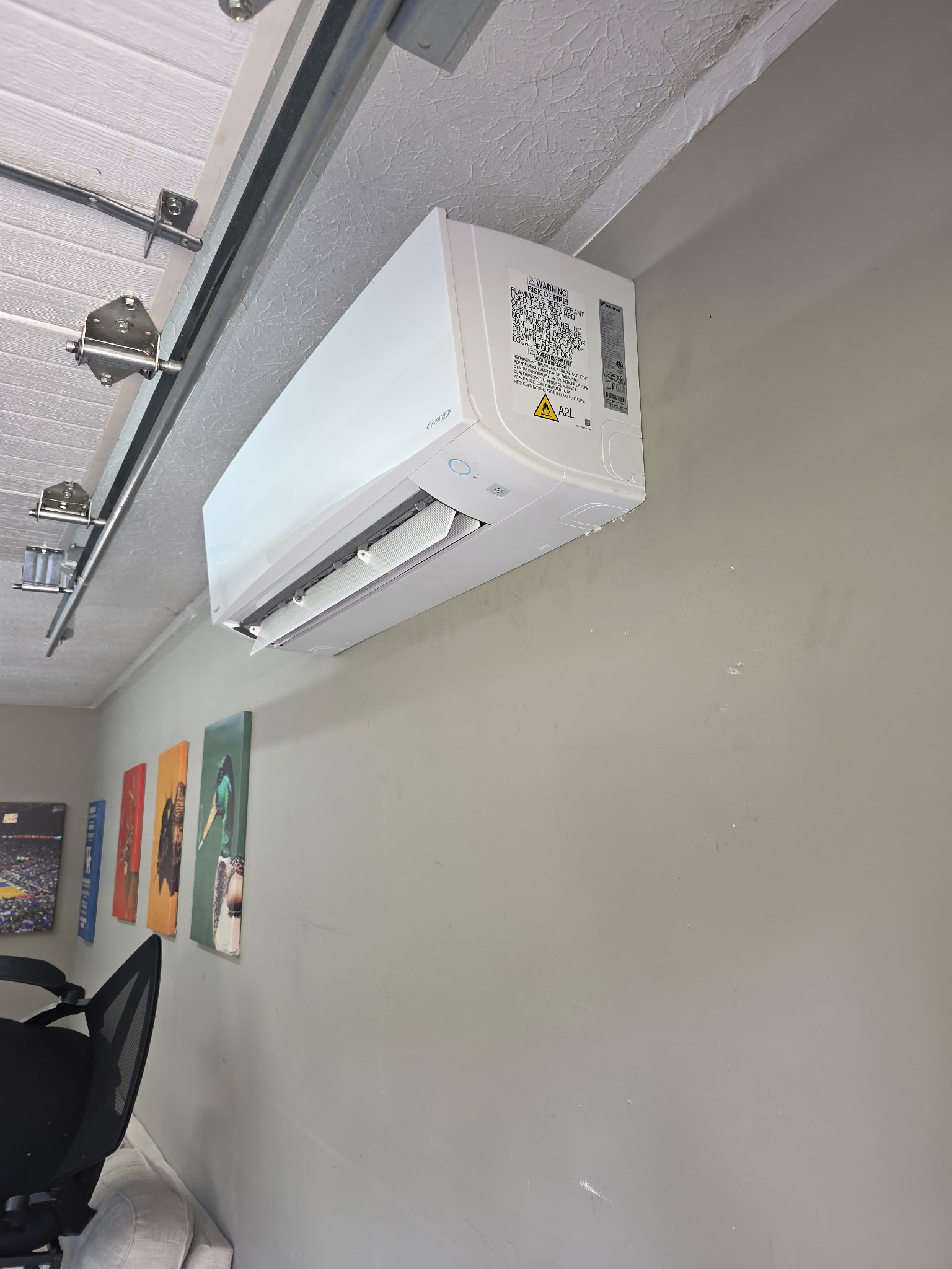 Completed mini-split indoor unit installed on garage wall with cover on after installation